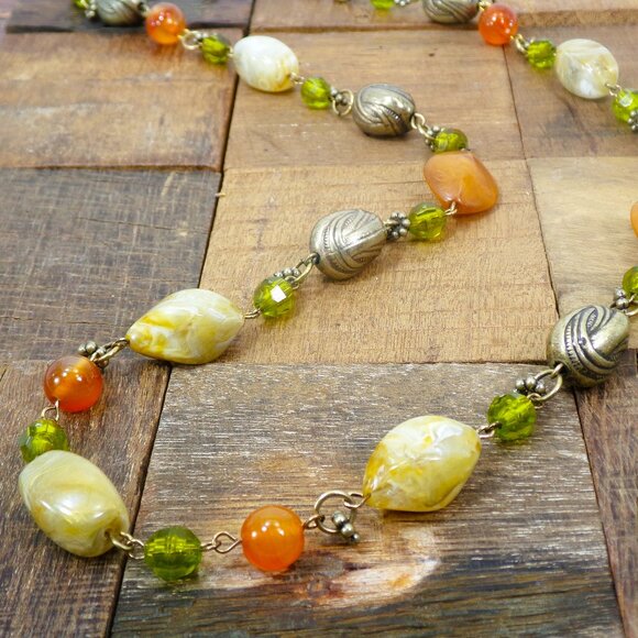 Multi color bead necklace with a mix of beige, green, and deep orange tones. - Picture 10 of 11